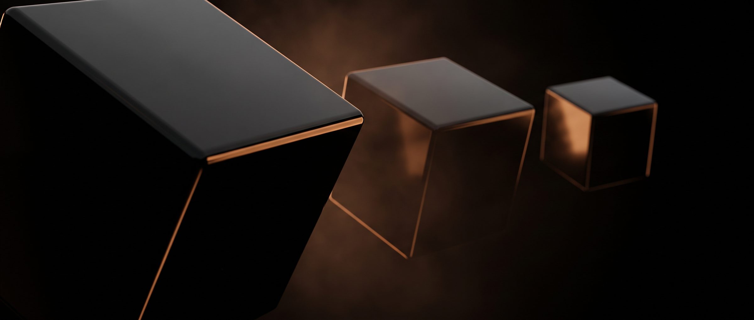 Three black glass cubes with amber edges